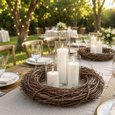 Natural grapevine wreath with glass pillar candles set outdoors on a rustic reception table - thumbnail number 6