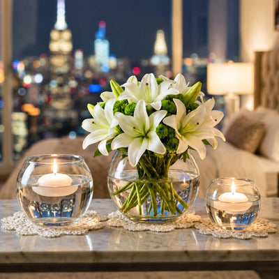White lilies in a bubble vase flanked by two smaller bubble vases with floating candles - thumbnail number 10