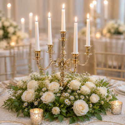 Lit 25-inch gold candelabra with white taper candles in a lush white floral centerpiece - thumbnail number 4