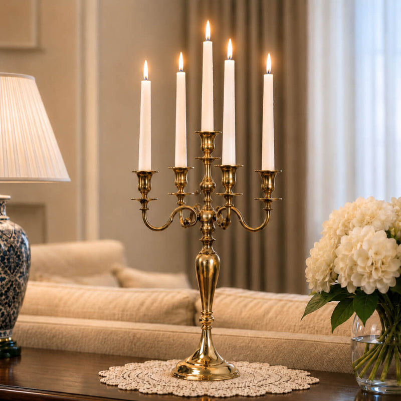 Lit 25-inch gold candelabra with five white taper candles on a wooden console table - thumbnail number 8