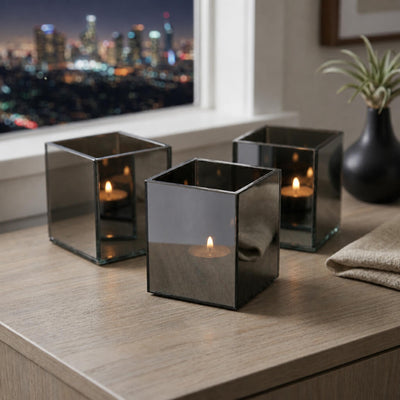 Three lit mirrored candle holders on wooden table with skyline view - thumbnail number 7