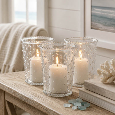 Three lit white pillars in a Hobnail Candle Holder trio on a coastal wooden console table - thumbnail number 7