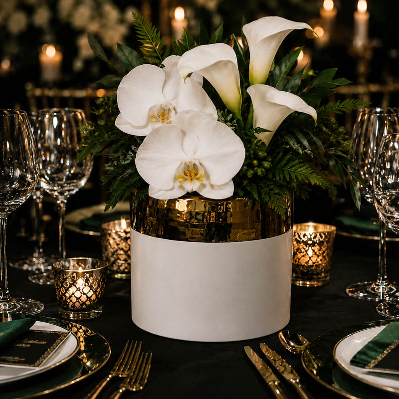7.5" x 6.25" white and gold ceramic Claire pot filled with white orchids and calla lilies on a table - thumbnail number 5