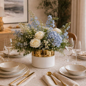 7.5" x 6.25" white and gold ceramic Claire vase holding a blue and white floral arrangement on a dining table - thumbnail number 7