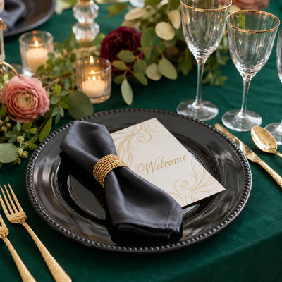 Black beaded charger plate on a green table setting - thumbnail number 3