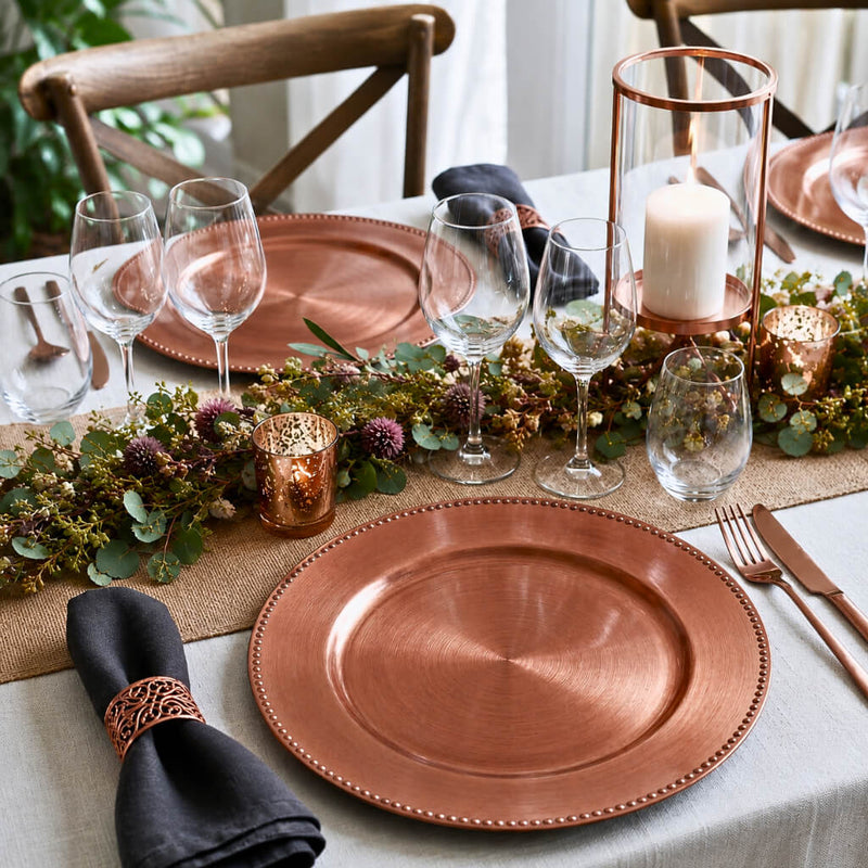 Copper beaded charger plates set on a formal dining table with elegant decor - thumbnail number 3