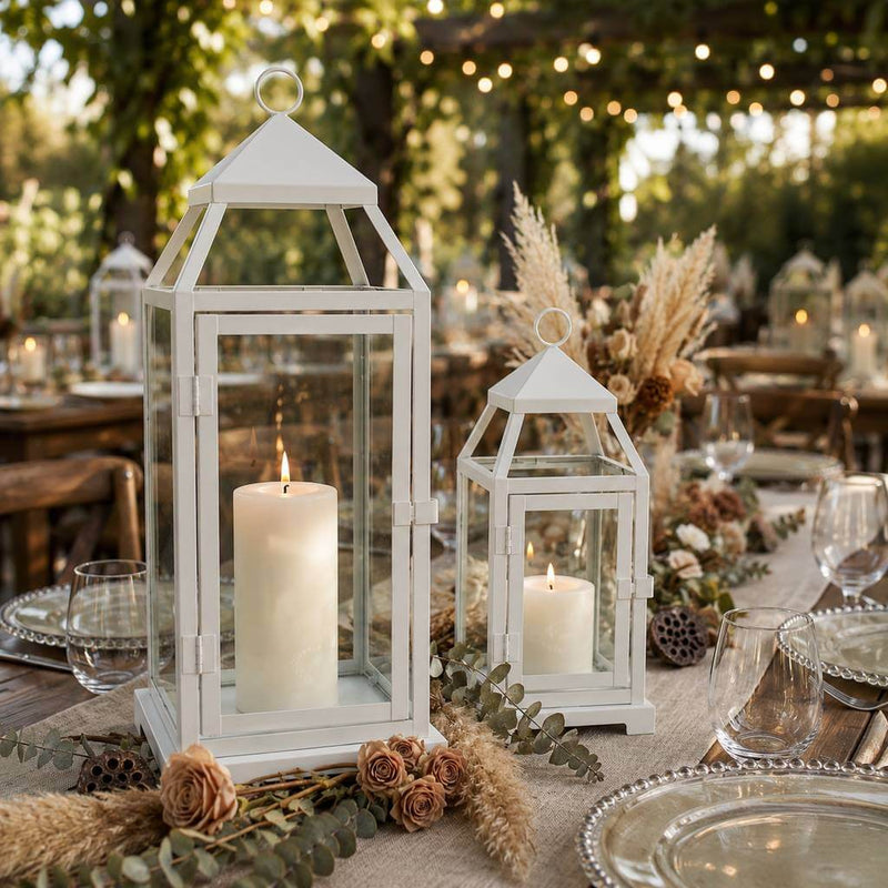 White contemporary metal lanterns with lit candles as centerpieces on an outdoor event table - thumbnail number 2
