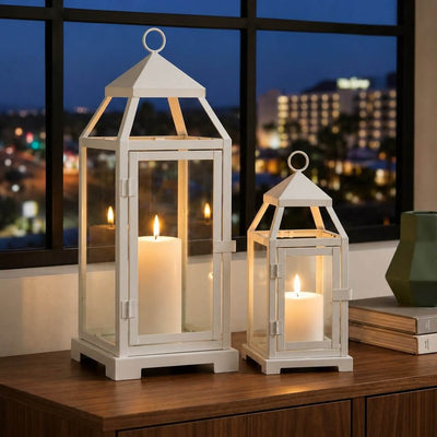 White contemporary metal lanterns with lit candles on a table by a window - thumbnail number 6