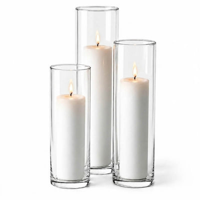 Three lit white pillar candles in staggered clear glass cylinder vases - thumbnail number 3
