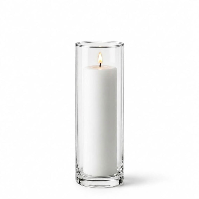 Lit white pillar candle inside a tall clear glass cylinder vase - thumbnail number 3