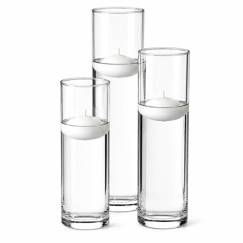 Three tall glass cylinder vases of varying heights filled with water and floating white candles - thumbnail number 4