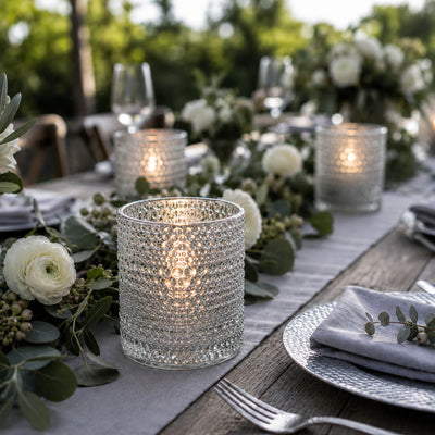 Pearly silver candle holders glowing on an elegant outdoor table with white flowers - thumbnail number 4