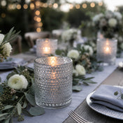 Pearly silver candle holder glowing on an elegant outdoor table with white flowers - thumbnail number 3