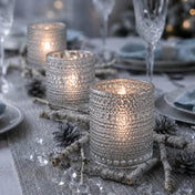 Pearly silver candle holders glowing on a winter-themed table with rustic decor - thumbnail number 4