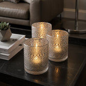Set of glowing pearly silver candle holders on a modern black coffee table - thumbnail number 6