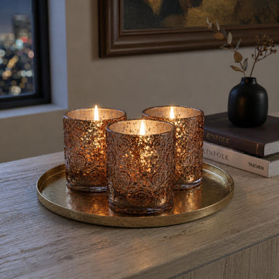 Rose gold mercury glass candle holders glowing on tray in cozy home setting - thumbnail number 7