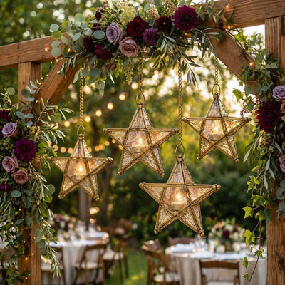 Decorative arch with star-shaped lanterns and floral arrangements at an outdoor event. - thumbnail number 4