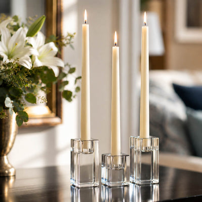 Three lit white taper candles in square glass holders on a dark table - thumbnail number 5