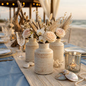 Rustic ceramic vases with flowers and driftwood on a beach wedding table - thumbnail number 5