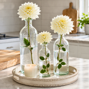 White dahlias in clear apothecary glass bottles on a beaded tray - thumbnail number 7