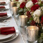 Formal dining table with silver candle holders and red floral decor - thumbnail number 6
