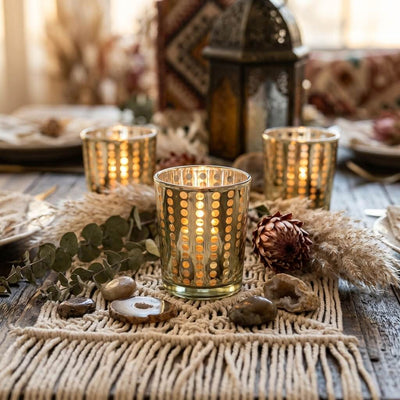 Decorative candles on a table with a textured tablecloth and lantern in the background - thumbnail number 6