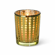 Small gold dotted glass holder with a glowing lit candle inside on a white background - thumbnail number 3