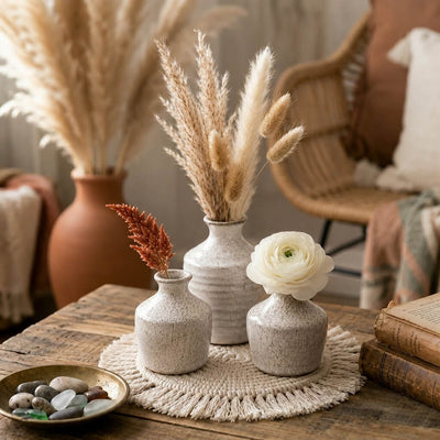 Speckled bud vases with dried stems and a flower on a macrame mat - thumbnail number 6