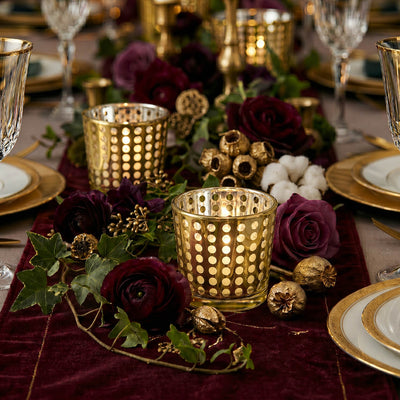 Gold dotted votive holders on a velvet runner with deep red roses and gold-rimmed china - thumbnail number 6