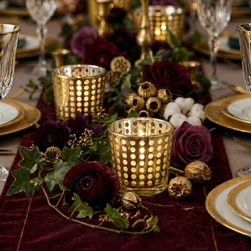 Gold dotted votive holders on a velvet runner with deep red roses and gold-rimmed china - thumbnail number 6