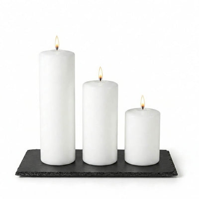 Three lit white pillar candles staggered on a Rectangle Natural Slate Coaster - thumbnail number 3