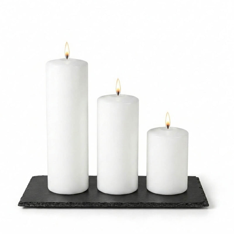Three lit white pillar candles staggered on a Rectangle Natural Slate Coaster - thumbnail number 3