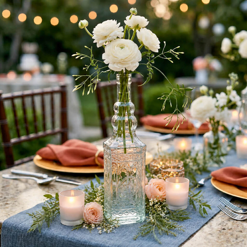 Vintage square glass bottle with white flowers on a tablescape in a garden - thumbnail number 5