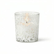 White lace design votive candle holder with lit candle on white background - thumbnail number 3