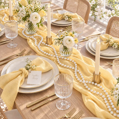 Yellow table runner draped with glossy white faux pearl beads and floral centerpieces - thumbnail number 6