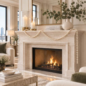 Fireplace mantel styled with candles, a vase of greenery, and a draped strand of white faux pearls - thumbnail number 9