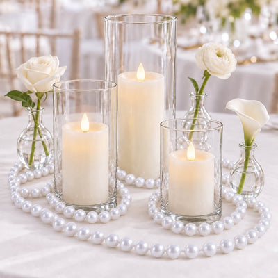Glass cylinder vases with lit candles, surrounded by faux pearl strands and white flowers - thumbnail number 5