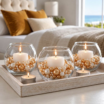 Three glass bowl vases with lit candles surrounded by off-white and gold pearls on a tray - thumbnail number 7
