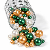 A glass jar spilling green, gold, and white pearl beads - thumbnail number 1