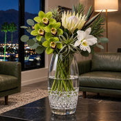 A tall glass vase with flowers sitting on a table, filled with clear water gel beads - thumbnail number 8