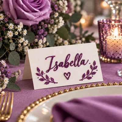 Place card with the name Isabella written in purple glitter, surrounded by floral decor - thumbnail number 2