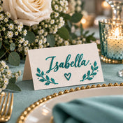 Place card with the name Isabella written in turquoise glitter, surrounded by floral decor - thumbnail number 7
