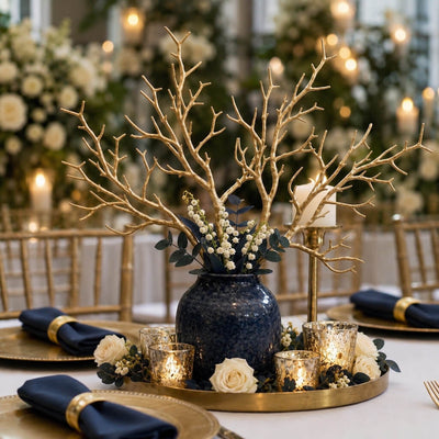 Metallic gold manzanita branches in a blue vase centerpiece on a dining table - thumbnail number 4