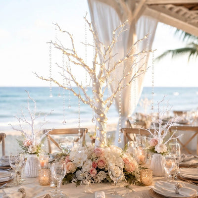 White manzanita tree centerpiece with fairy lights and crystal chains on a beach wedding table - thumbnail number 2