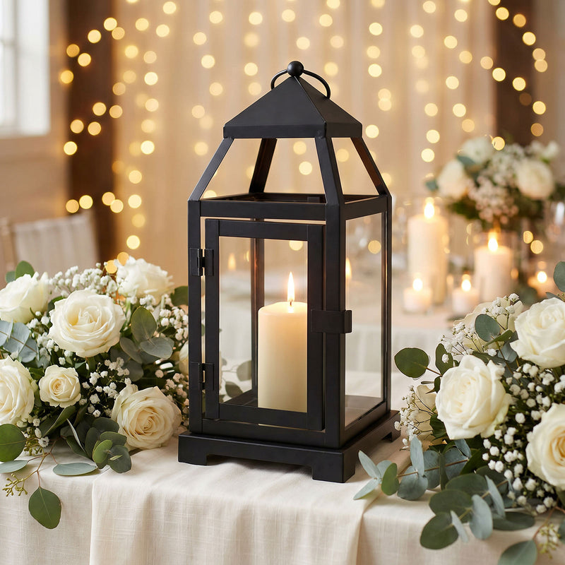 Decorative black metal lantern centerpiece with lit pillar candle and floral arrangement - thumbnail number 2