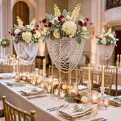Tall crystal beaded acrylic stands displaying floral arrangements at a wedding reception - thumbnail number 3