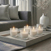 Five lit white unscented candles in frosted holders on a tray in a luxury spa style living room - thumbnail number 9