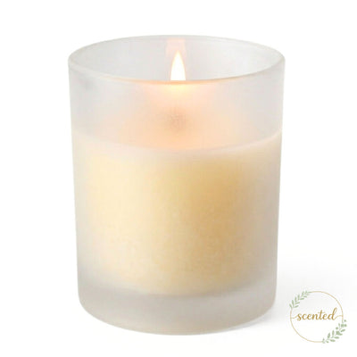 A lit vanilla scented candle glowing softly inside Frosted Votive Holders against white - thumbnail number 2