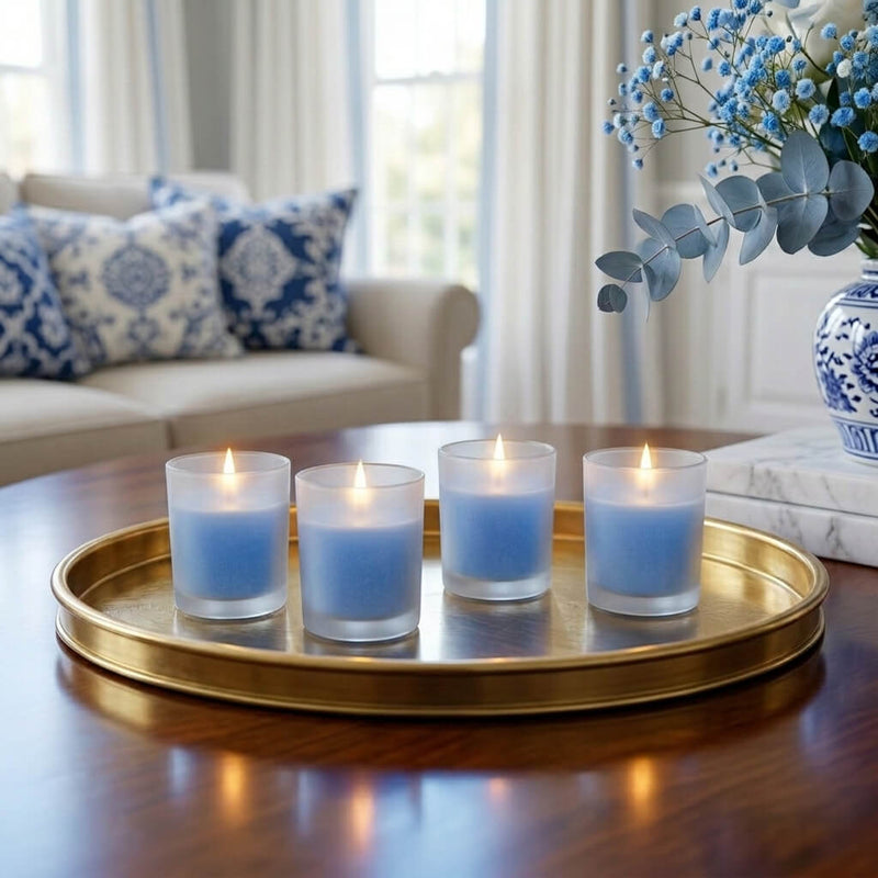 Four blue candles in Frosted Votive Holders on a gold tray, with living room decor. - thumbnail number 9