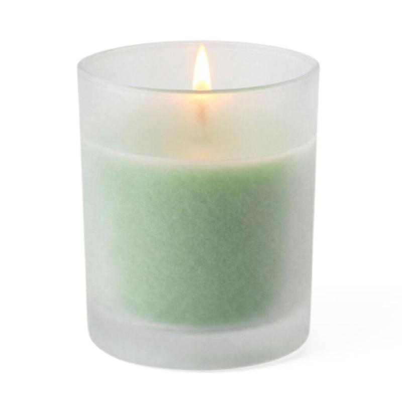 A single lit green candle glowing softly inside Frosted Votive Holders - thumbnail number 2